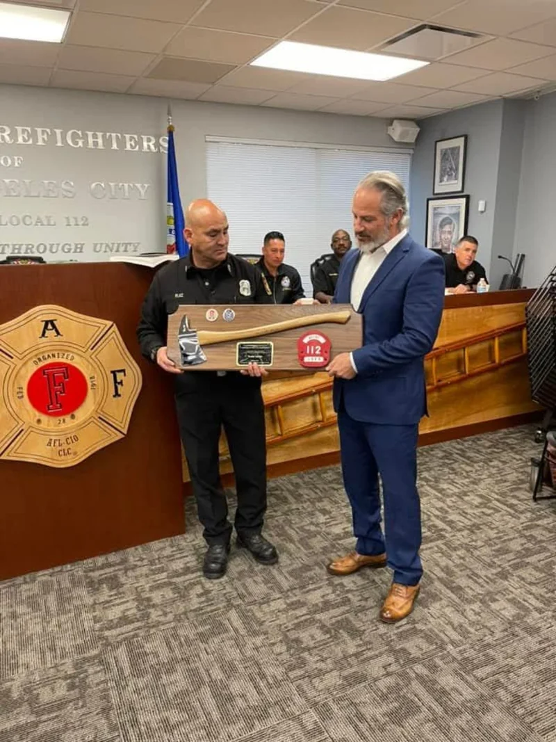 A presentation of a mounted ceremonial axe at the Local 112 hall.